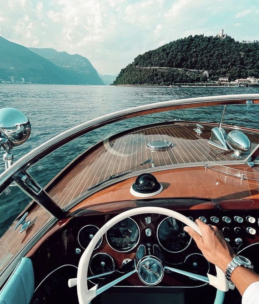 Photo of a man giving a talk on stage with blue curtains behind him.