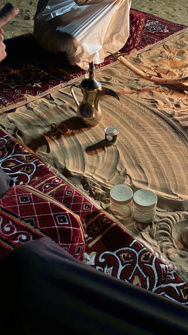 Photo of a man giving a talk on stage with blue curtains behind him.